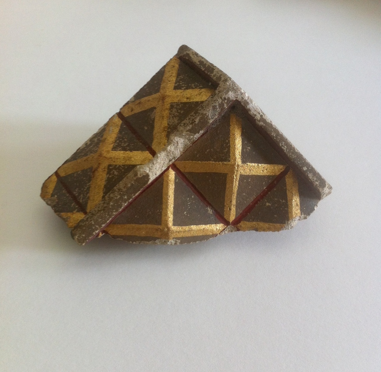 Stukje bouwfragment met vierkanten en gouden kruisjes